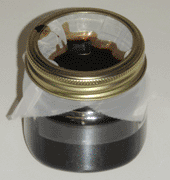 Boiled linseed oil being filtered into a jar