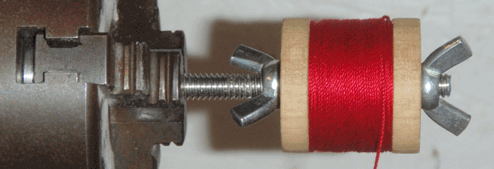 Spool being wound on lathe